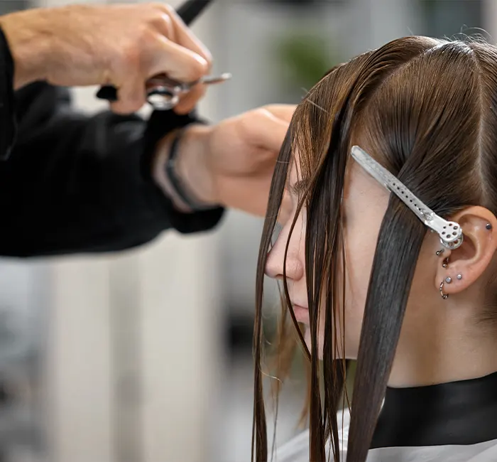 Hair Stylist Giving a Haircut at Salon