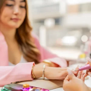 Manicurist Polishing the Nails of a Client in a Salon