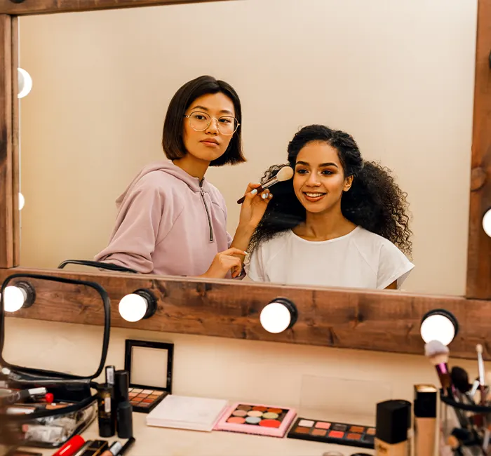 Two People Looking in the Dressing Room Mirror