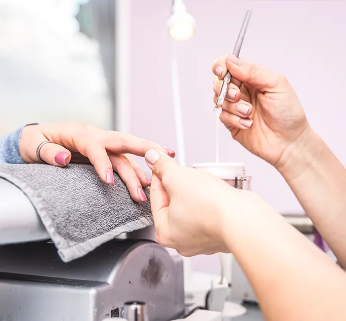 Woman Getting Nail Treatment in a Beauty Salon
